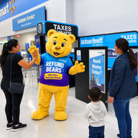 Refund Bear mascot costume in use at a Jackson Hewitt community event