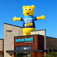 Yellow Refund Bear giant inflatable displayed above a Jackson Hewitt storefront